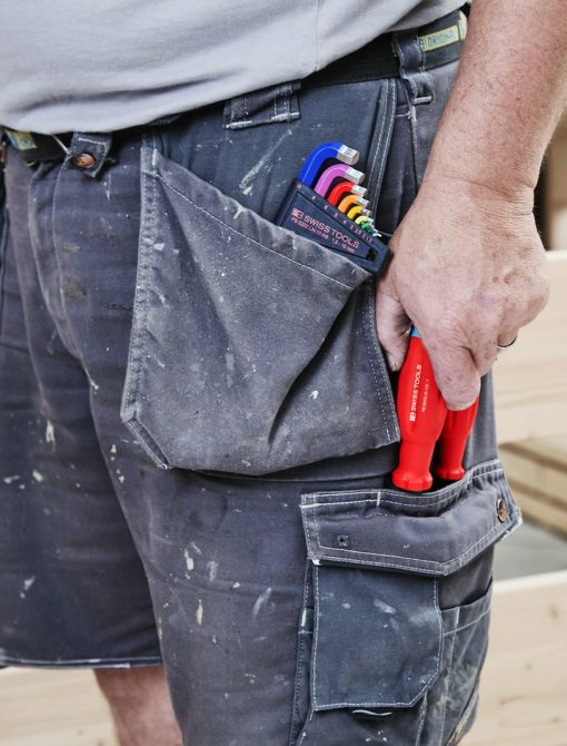 A carpenter's tool-filled pocket shows his trade.